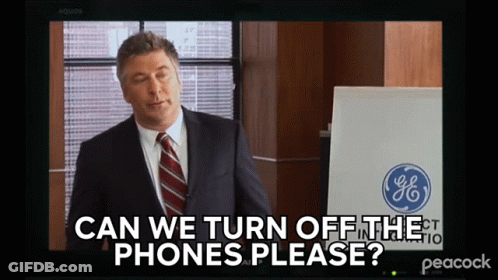 A Man In A Suit And Tie Is Asking If We Can Turn Off The Phones GIF
