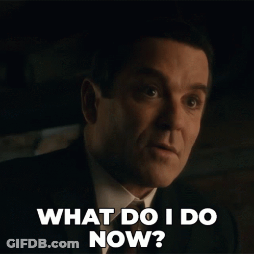 A Man In A Suit And Tie Is Asking What Do I Do Now GIF