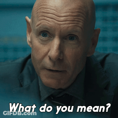 A Man In A Suit And Tie Is Asking What Do You Mean GIF