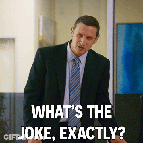 A Man In A Suit And Tie Is Asking " What 'S The Joke Exactly " GIF