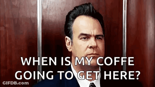 A Man In A Suit And Tie Is Asking When Is My Coffe Going To Get Here . GIF