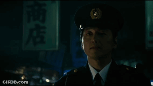 A Man In A Suit And Tie Is Being Attacked By A Monster With Long Tentacles GIF