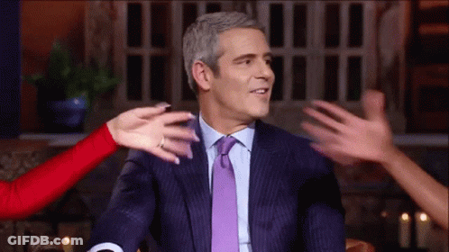 Man In Suit Hugged By Group Of People GIF