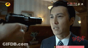 A Man In A Suit And Tie Is Being Shot With A Gun In A Room GIF