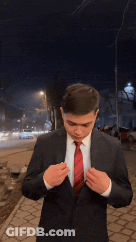 A Man In A Suit And Tie Is Blowing A Kiss At The Camera GIF