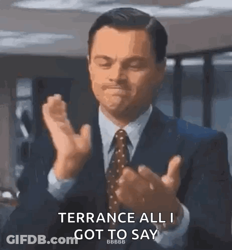 A Man In A Suit And Tie Is Clapping His Hands And Saying Terrace All I Got To Say . GIF