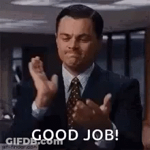 A Man In A Suit And Tie Is Clapping His Hands And Says `` Good Job '' . GIF