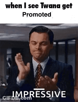 A Man In A Suit And Tie Is Clapping His Hands In A Gif . GIF