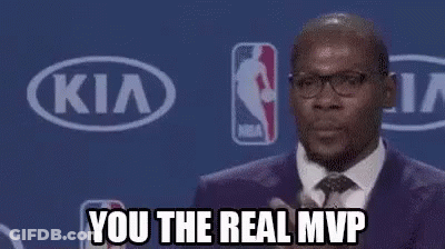 A Man In A Suit And Tie Is Clapping His Hands In Front Of A Kia Sign . GIF