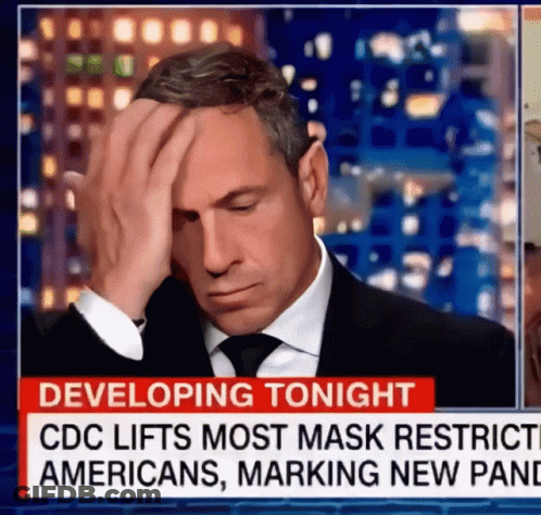 A Man In A Suit And Tie Is Covering His Face In Front Of A News Report That Says " Developing Tonight " GIF