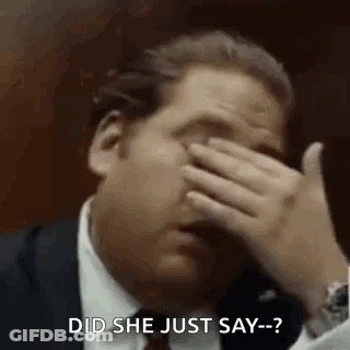 A Man In A Suit And Tie Is Covering His Face With His Hand And Saying `` Did She Just Say '' . GIF