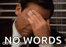 A Man In A Suit And Tie Is Covering His Face With His Hands And The Words `` No Words '' Are Behind Him . GIF