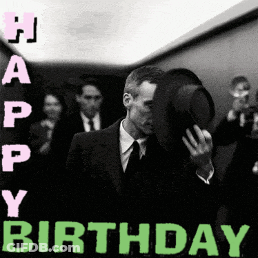 A Man In A Suit And Tie Is Covering His Face With His Hat And The Words Happy Birthday Are Above Him GIF
