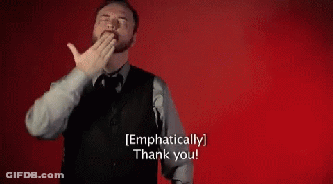A Man In A Suit And Tie Is Covering His Mouth With His Hand And Says `` Emphatically Thank You '' . GIF