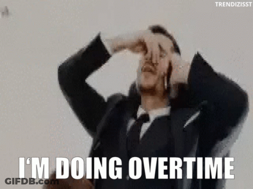 A Man In A Suit And Tie Is Covering His Nose With His Hand . GIF