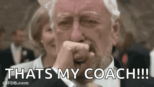 A Man In A Suit And Tie Is Crying And Covering His Mouth With His Fist . GIF