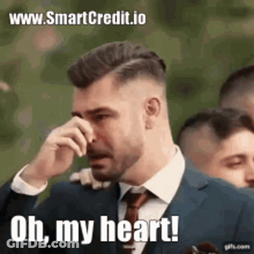 A Man In A Suit And Tie Is Crying And Saying `` Oh , My Heart '' . GIF