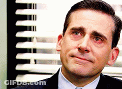 A Man In A Suit And Tie Is Crying In Front Of A Window With Blinds . GIF