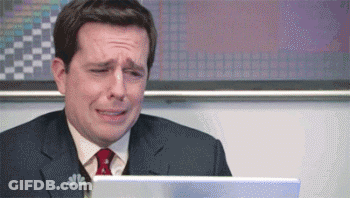 A Man In A Suit And Tie Is Crying While Sitting In Front Of A Laptop . GIF
