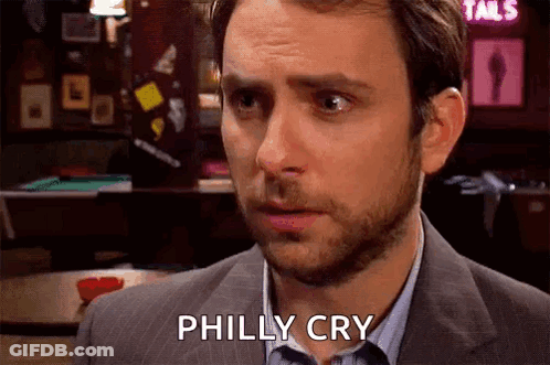 A Man In A Suit And Tie Is Crying While Standing In Front Of A Bar . GIF