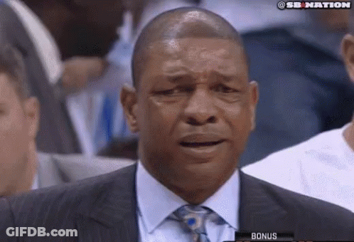 A Man In A Suit And Tie Is Crying While Watching A Basketball Game GIF