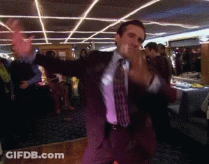 A Man In A Suit And Tie Is Dancing GIF