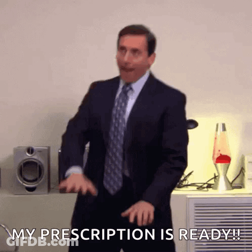 A Man In A Suit And Tie Is Dancing And Saying " My Prescription Is Ready ! " GIF