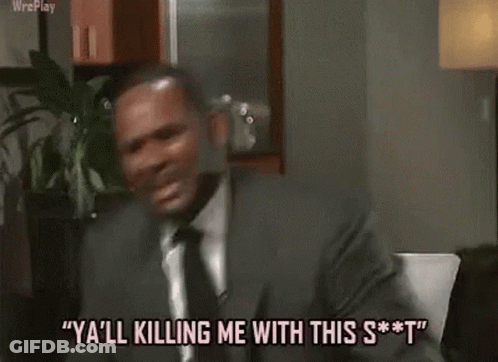 A Man In A Suit And Tie Is Dancing In A Kitchen . GIF