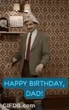 A Man In A Suit And Tie Is Dancing In A Living Room . GIF