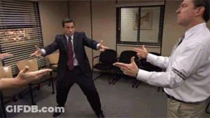 A Man In A Suit And Tie Is Dancing In A Room GIF