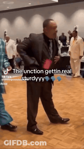 A Man In A Suit And Tie Is Dancing In A Room With A Caption That Says The Junction Gettin Real Sturdyy GIF