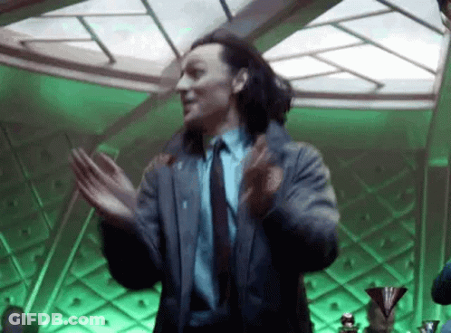 A Man In A Suit And Tie Is Dancing In A Room With Green Lights . GIF