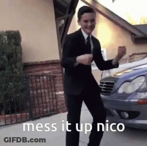 A Man In A Suit And Tie Is Dancing In Front Of A Car With The Words Mess It Up Nico Below Him GIF