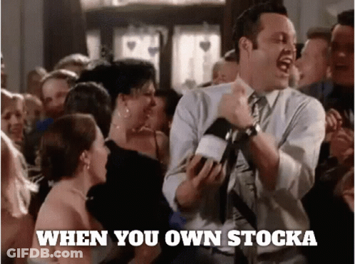 A Man In A Suit And Tie Is Dancing In Front Of A Crowd With The Words " When You Own Stocka " Written Below Him GIF