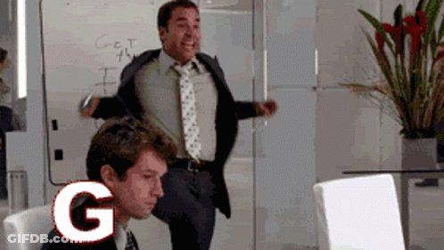 A Man In A Suit And Tie Is Dancing In Front Of A White Board That Says Get The I On It GIF