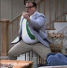 A Man In A Suit And Tie Is Dancing In Front Of Stairs GIF