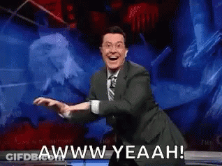 A Man In A Suit And Tie Is Dancing On A Stage And Says Awww Yeahh ! GIF