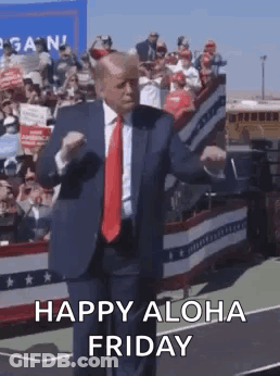 A Man In A Suit And Tie Is Dancing On A Stage . GIF