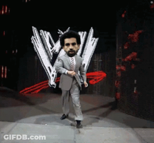 A Man In A Suit And Tie Is Dancing On A Stage In Front Of A W Logo GIF