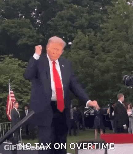 A Man In A Suit And Tie Is Dancing On A Stage . GIF