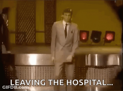 A Man In A Suit And Tie Is Dancing On A Stage With The Words Leaving The Hospital Behind Him . GIF