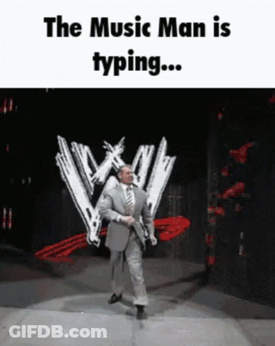 A Man In A Suit And Tie Is Dancing On A Stage With The Words " The Music Man Is Typing " GIF