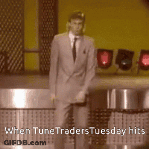 A Man In A Suit And Tie Is Dancing On A Stage With The Words When Tunetraders Tuesday Hits Below Him GIF