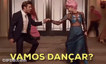 A Man In A Suit And Tie Is Dancing With A Woman In A Blue Dress With The Words Vamos Dancar Written Above Them GIF
