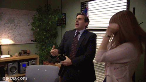 A Man In A Suit And Tie Is Dancing With A Woman In A Pink Shirt GIF