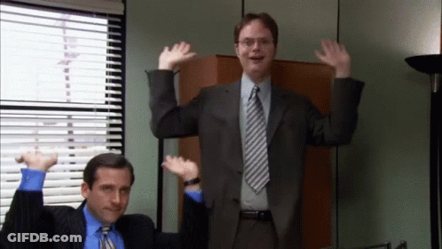 A Man In A Suit And Tie Is Dancing With Another Man GIF
