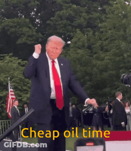 A Man In A Suit And Tie Is Dancing With The Words Cheap Oil Time Behind Him GIF