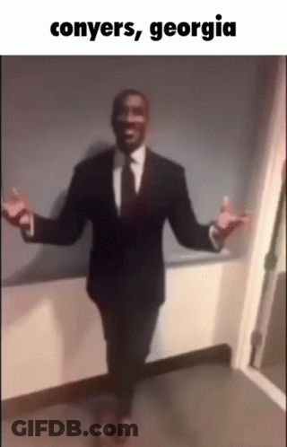 A Man In A Suit And Tie Is Dancing With The Words Conyers Georgia Written Below Him GIF