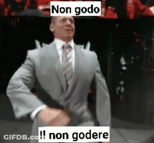 A Man In A Suit And Tie Is Dancing With The Words Non Godo Written Above Him GIF