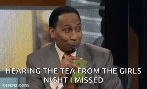 A Man In A Suit And Tie Is Drinking A Green Drink From A Plastic Cup . GIF
